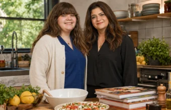 Alex Guarnaschelli's daughter Ava Clark smiling with her mother in a kitchen