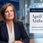 April Anthony in executive boardroom setting with Forbes self-made women healthcare entrepreneur graphic