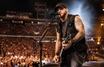 Brantley Gilbert’s live concert coverage featuring a country rock singer playing guitar on stage before a packed crowd.
