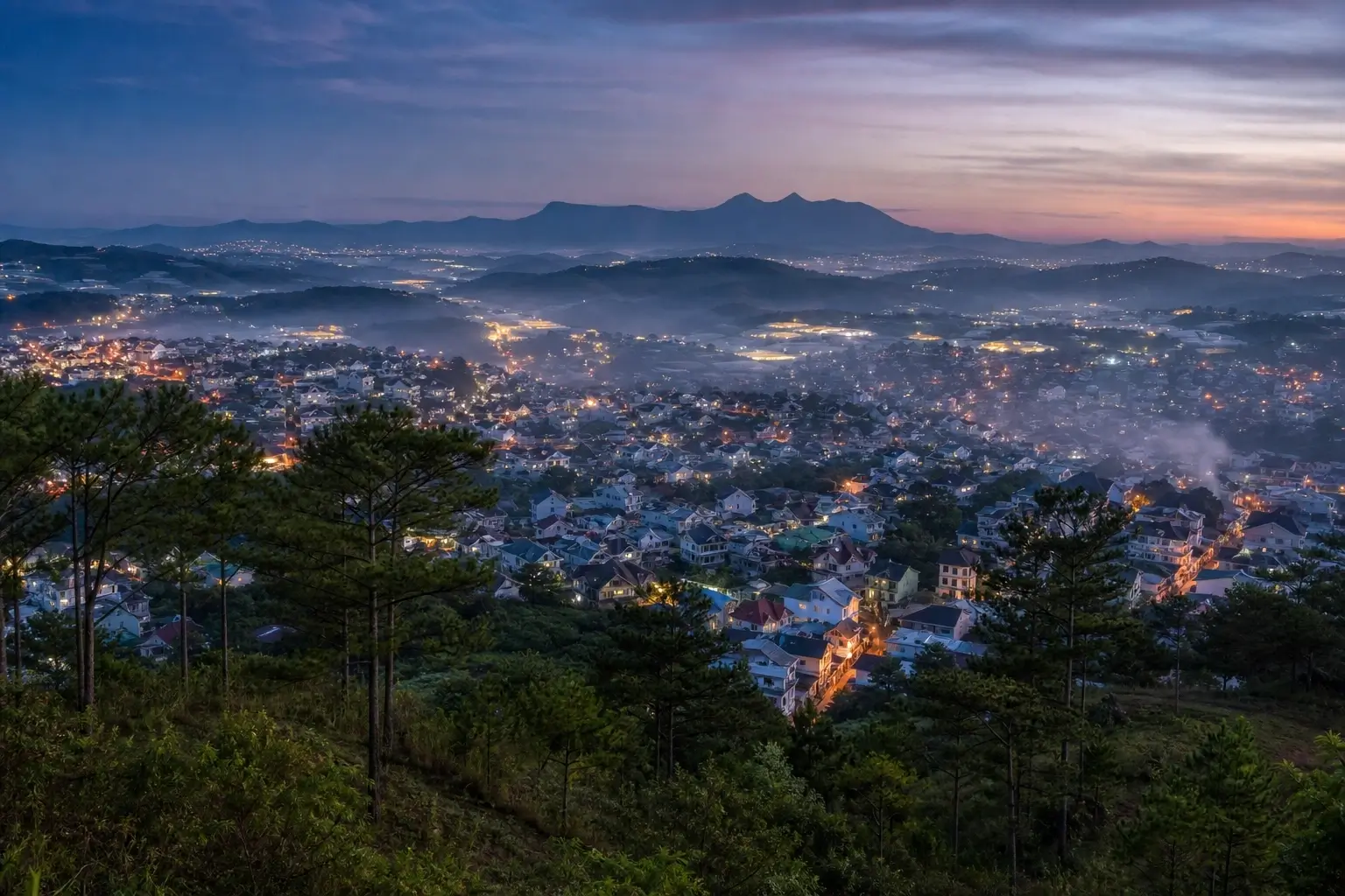Da Lat city at twilight with pine forests, rolling highlands, and Lang Biang mountain in Lam Dong, Vietnam