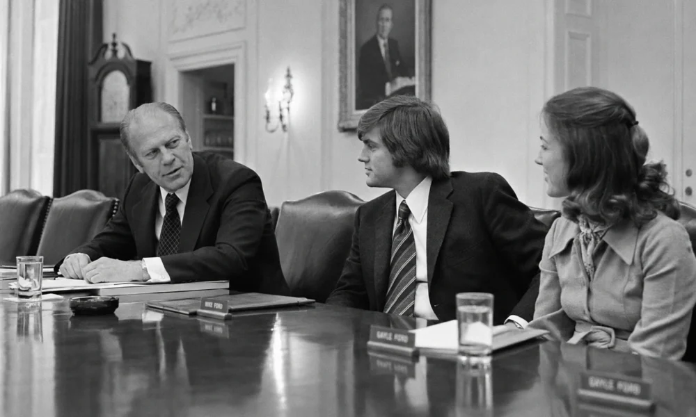 Gerald Ford speaks with Michael Ford and Gayle Ford in the White House Cabinet Room in 1975
