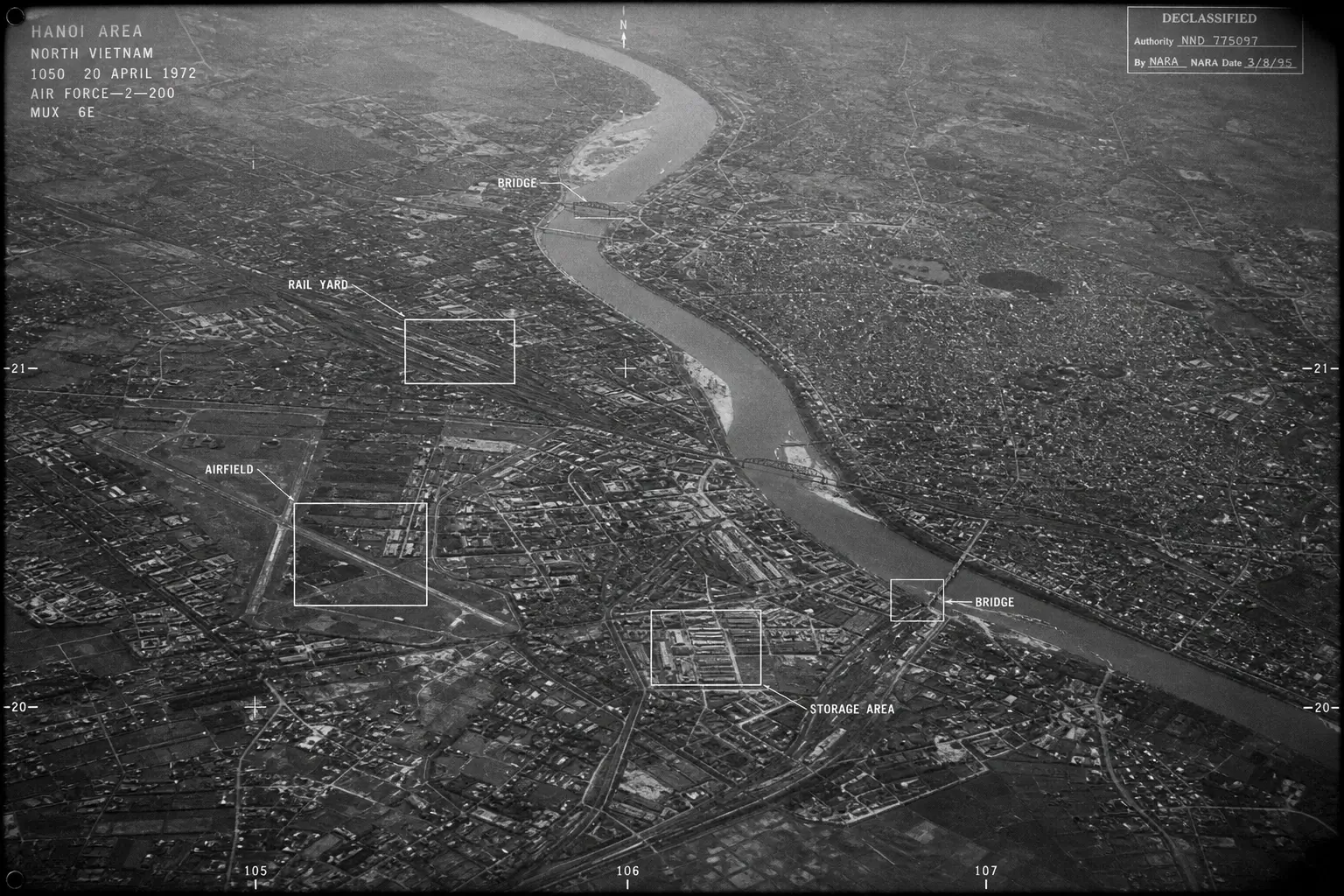 Declassified 1972 aerial reconnaissance photo of Hanoi showing bridges, rail yard, airfield and storage area