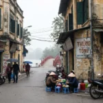 Hanoi Old Quarter street with food vendors near The Huc Bridge and Hoan Kiem Lake