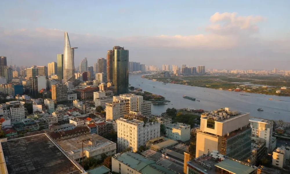 Ho Chi Minh City skyline and Saigon River viewed from a rooftop at golden hour