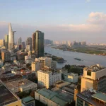 Ho Chi Minh City skyline and Saigon River viewed from a rooftop at golden hour
