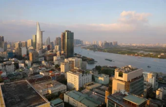 Ho Chi Minh City skyline and Saigon River viewed from a rooftop at golden hour