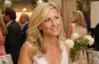 Kathryn Adams Limbaugh smiling at a formal public event with guests and floral decor in the background