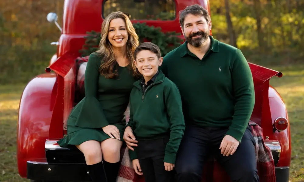 Illustrative family portrait for Kristy Greenberg husband article, showing a couple and child beside a red vintage truck