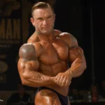 Lee Priest posing onstage at the 2006 IFBB Ironman Pro bodybuilding competition