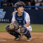 Marika Lyszczyk in Sonoma State Seawolves catcher gear crouching behind home plate