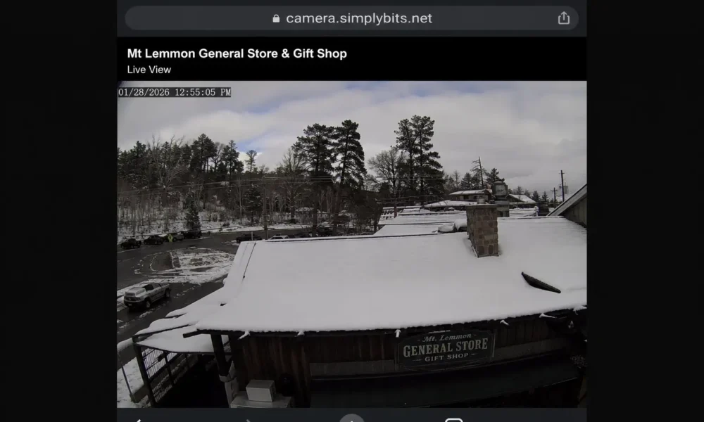 Mt Lemmon webcam live view showing snow on the General Store rooftop and surrounding mountain road conditions.