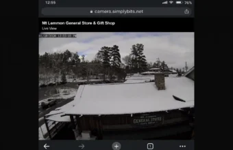 Mt Lemmon webcam live view showing snow on the General Store rooftop and surrounding mountain road conditions.