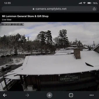Mt Lemmon webcam live view showing snow on the General Store rooftop and surrounding mountain road conditions.