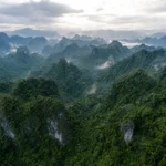 Aerial view of Phong Nha-Ke Bang karst mountains covered in dense jungle in central Vietnam