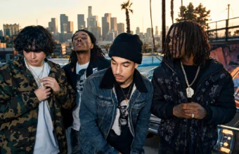 Shoreline Mafia-style hip-hop group promo photo with four artists in front of a Los Angeles skyline.