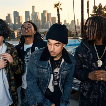 Shoreline Mafia-style hip-hop group promo photo with four artists in front of a Los Angeles skyline.
