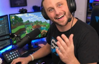 SSundee's gaming setup with headset, microphone, RGB keyboard, and Minecraft gameplay on monitors