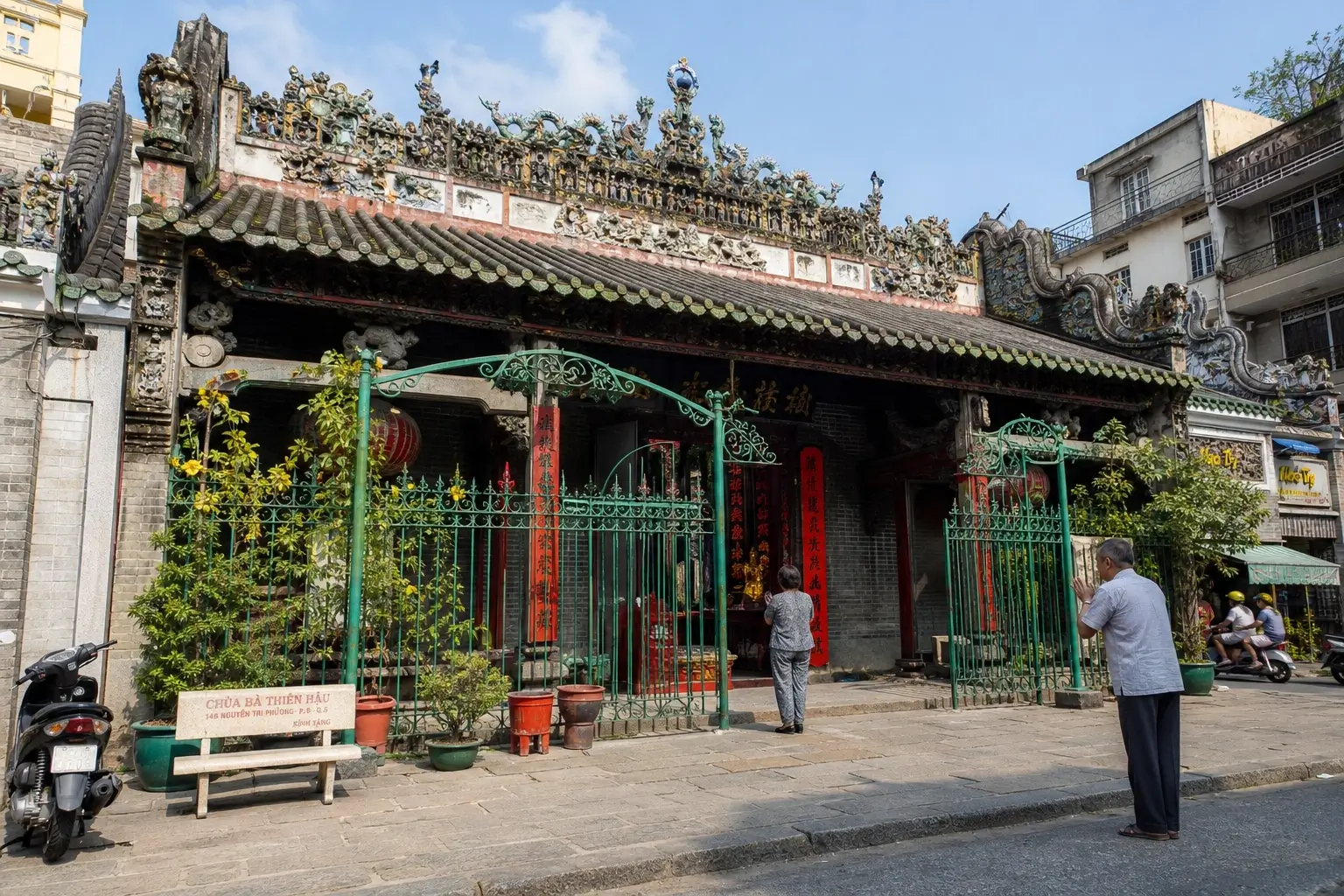 Thien Hau Temple exterior in District 5, Ho Chi Minh City, with ornate roof and green entrance gate.