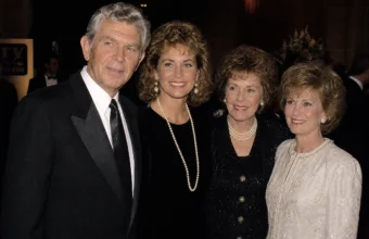 Dixie Griffith biography image with four people in formal evening attire at an event