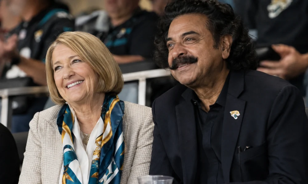Ann Carlson Khan and Shahid Khan smiling together at a Jacksonville Jaguars game.