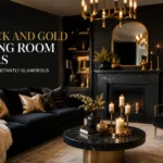 Black and gold living room with velvet sofa, gold mirror, chandelier, candles and dark fireplace.
