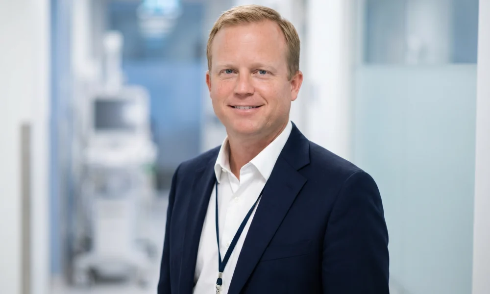 Professional headshot-style image for Brett Atkinson Nashville profile in a bright clinical hallway.