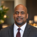 Dean Adkins MI professional portrait in a suit for biography profile