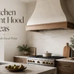 Kitchen vent hood ideas with a plaster range hood, wood trim, marble backsplash, and warm modern kitchen styling.