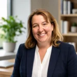 Maureen Fulton portrait-style image in navy blazer inside a modern office