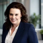 Rebecca Sneed profile-style portrait of a woman in a navy blazer in an office