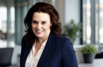 Rebecca Sneed profile-style portrait of a woman in a navy blazer in an office