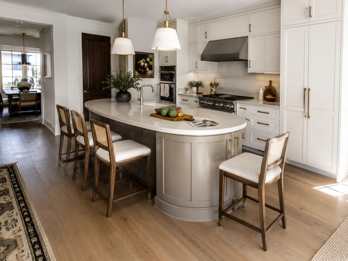Rounded corner kitchen island with counter-height chairs improving seating flow in a white modern kitchen