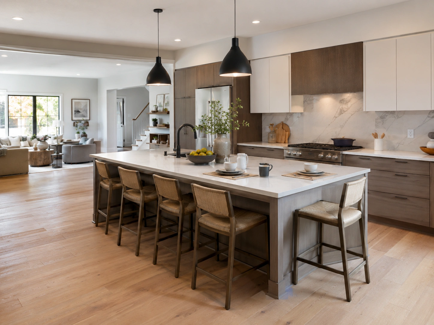 Two-sided kitchen island seating with woven counter stools in a warm open-plan kitchen