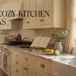 Cozy cream kitchen with farmhouse sink, open cookbook, herbs, lemons, and soft window light