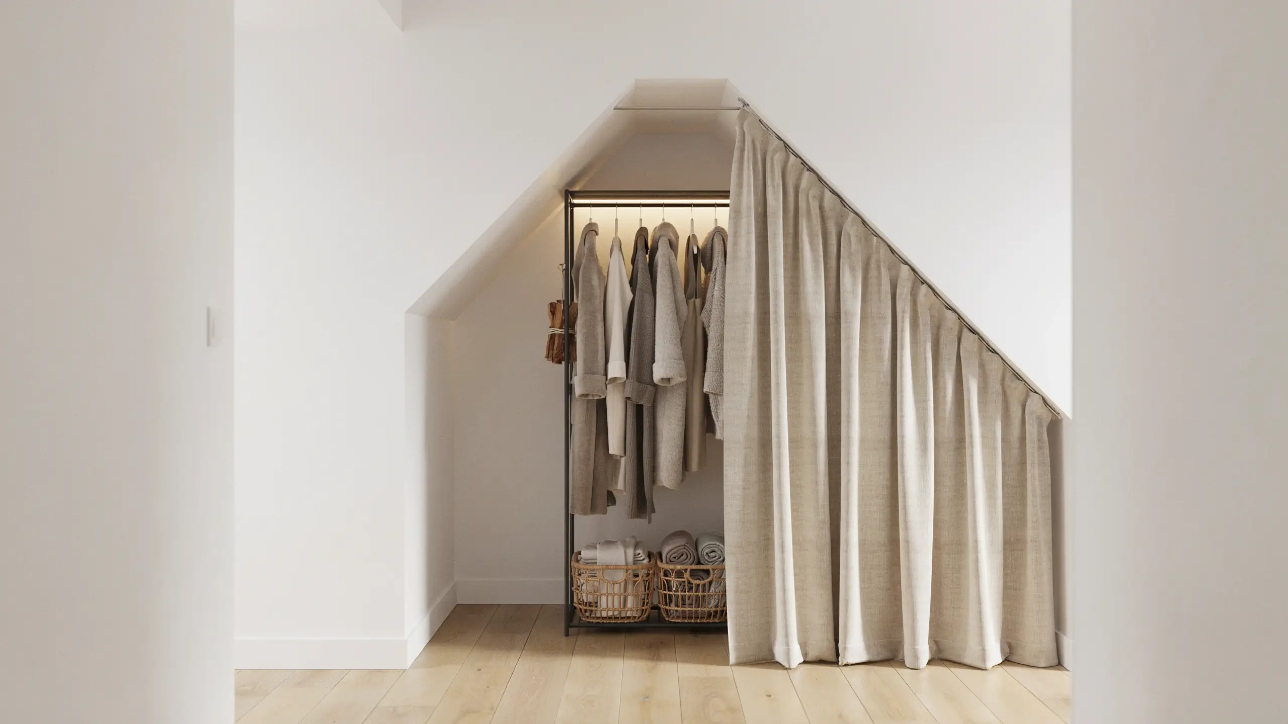 Beige linen curtain covering an open wardrobe system with hanging clothes and wicker baskets inside a sloped attic storage niche.