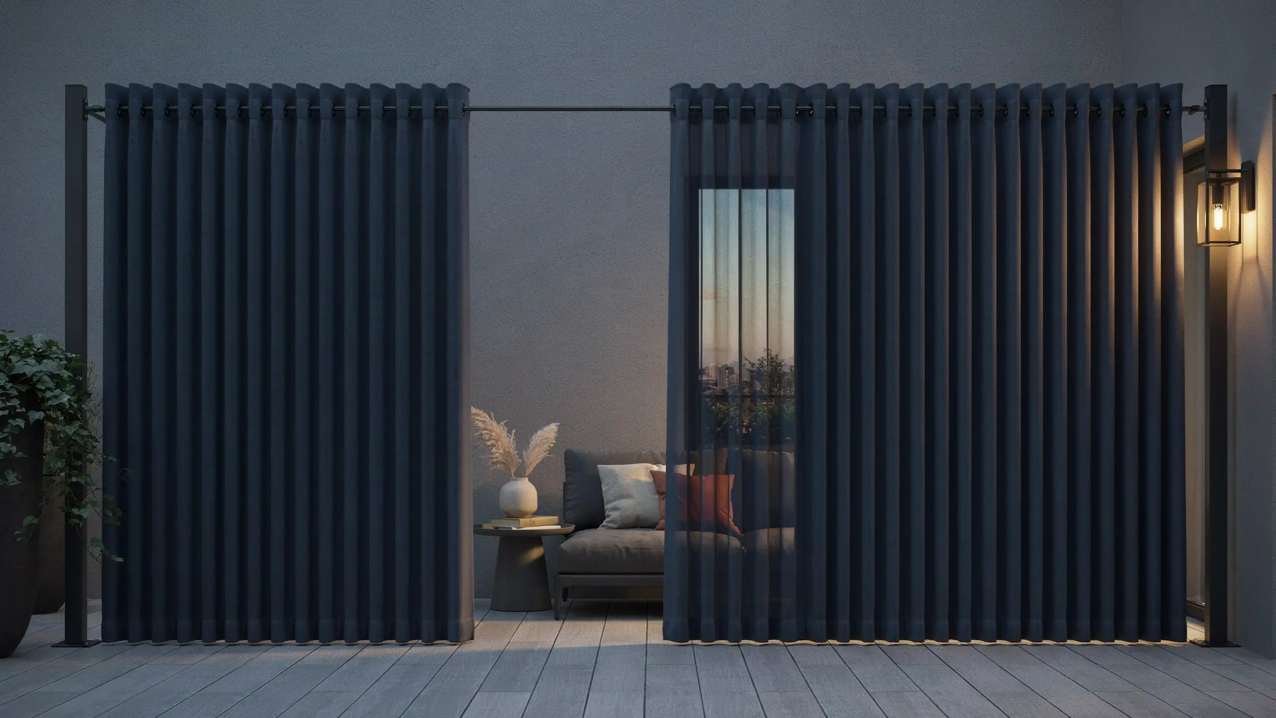 Close-up of dark charcoal grey weather-resistant outdoor curtains hanging from a black freestanding post kit, partially drawn open to reveal a cozy patio lounge area with a modern sofa and warm dusk lighting.
