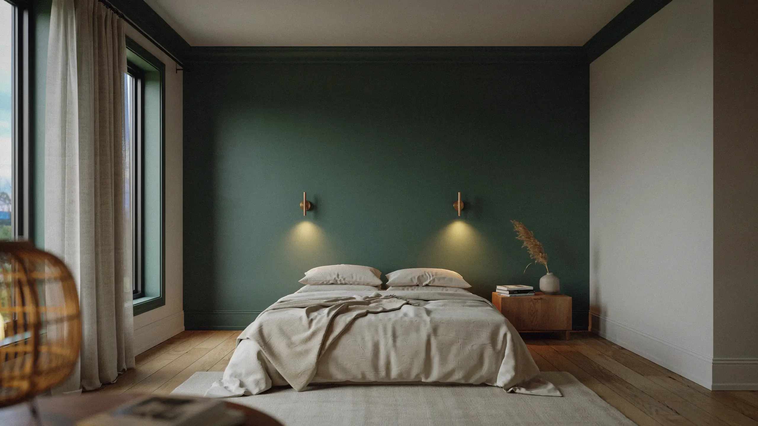 A minimalist bedroom with a moody dark forest green accent wall, illuminated by two warm brass wall sconces, featuring a bed with textured cream linens and a wooden nightstand holding a white vase with dried pampas grass. 