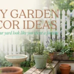 Sunlit rustic garden patio featuring a white picket fence, a macrame hanging planter with trailing vines, a wooden box of lavender and rosemary, and a vintage stone birdbath, representing 7 DIY decor ideas that look expensive on a budget.