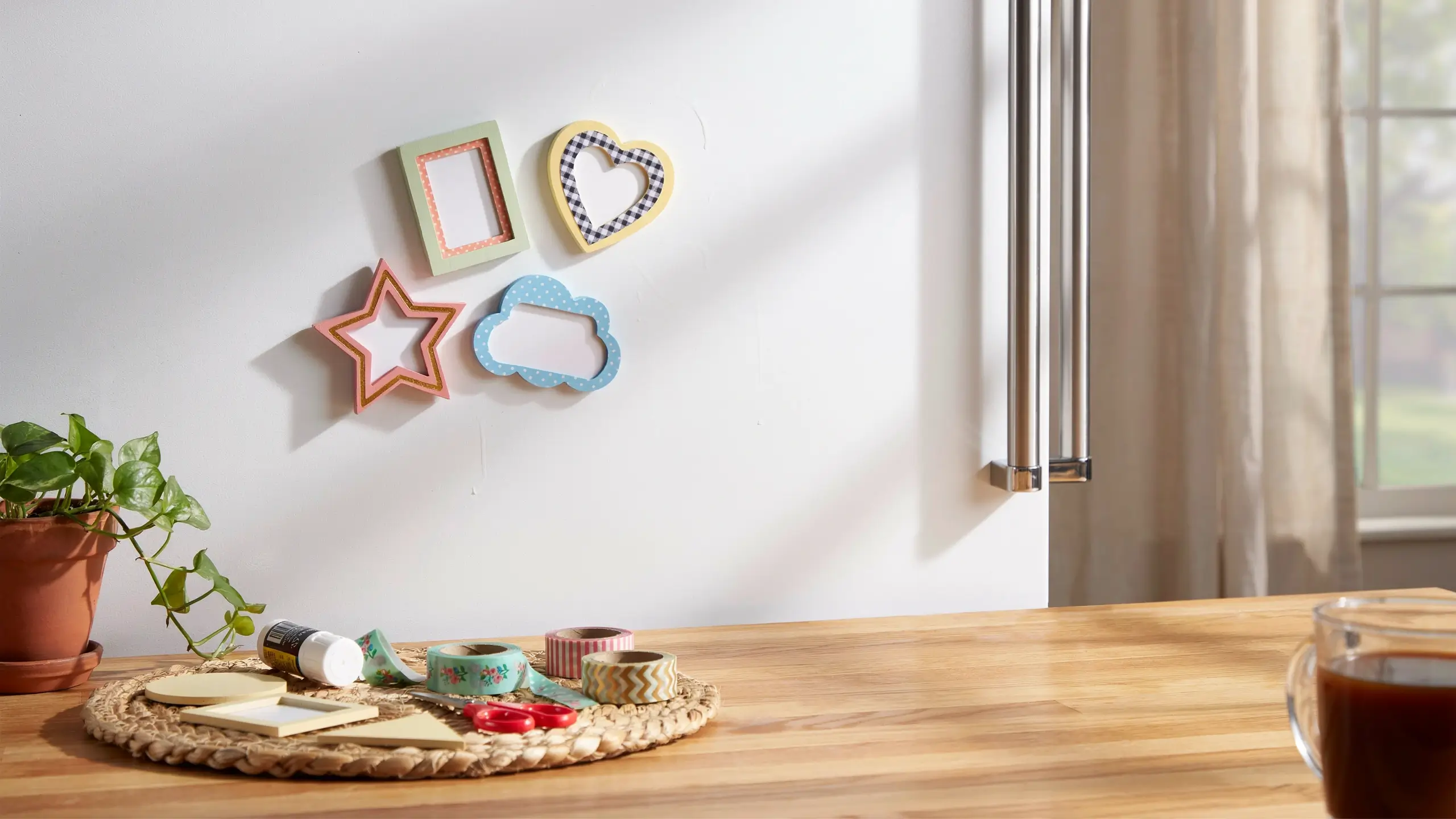 DIY photo frame magnets made from cardboard and craft paper for refrigerator decoration.
