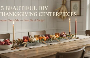 Rustic DIY Thanksgiving centerpiece with pumpkins, glass candle holders, and dried wheat on a wooden dining table.