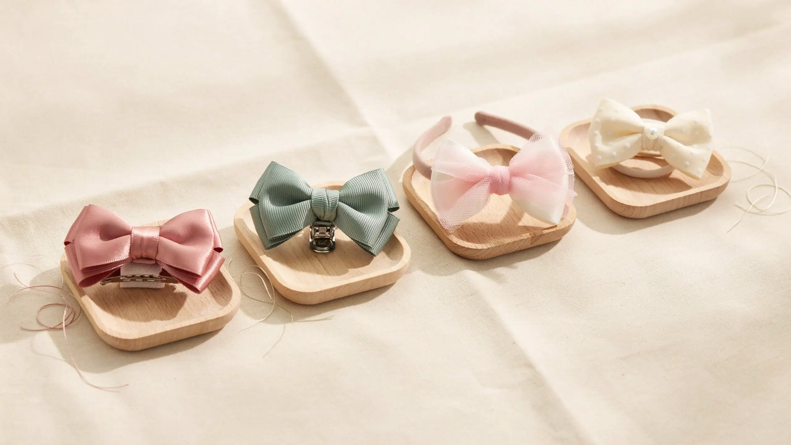 Alt Text: Four handmade hair bows attached to clips and headbands, showing different secure attachment methods.