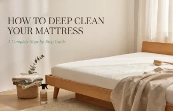 Clean mattress in a bright bedroom with a brush and spray bottle for a step-by-step deep cleaning guide.