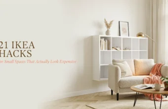 Bright small living room featuring a white floating IKEA shelving unit hack styled with minimal decor, next to a textured beige armchair and round wooden coffee table.