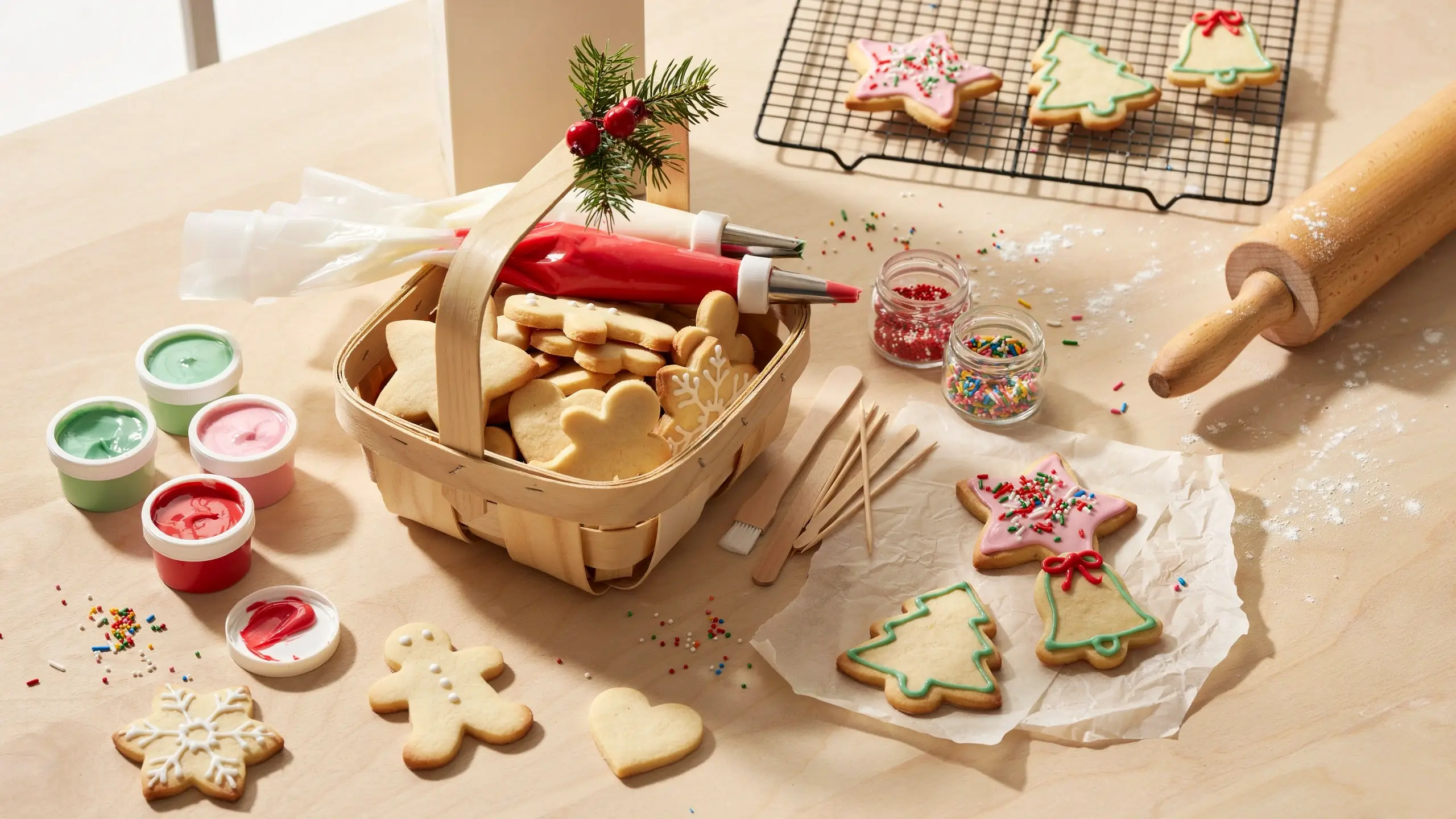 Kids’ Christmas cookie decorating kit with sugar cookies, icing bags, sprinkles, and a rolling pin.