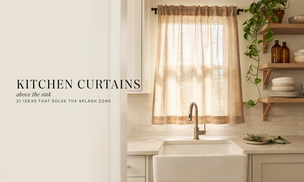 Beige linen kitchen curtains above a farmhouse sink with open shelves and trailing plant.