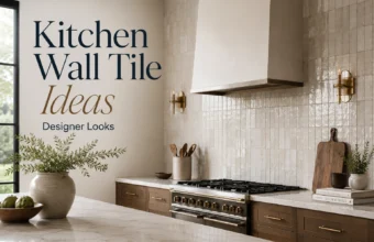 Full-height glossy kitchen wall tile with wood cabinets, brass sconces, range hood, and marble island.