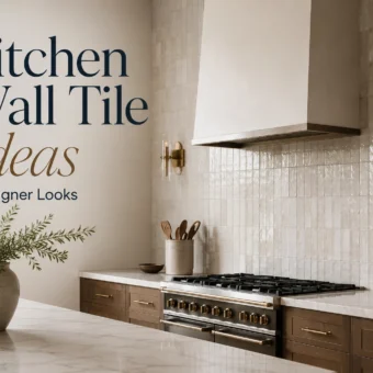 Full-height glossy kitchen wall tile with wood cabinets, brass sconces, range hood, and marble island.