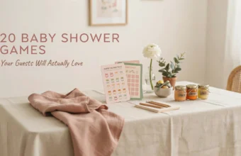 A minimalist baby shower game station featuring a 'Guess the Baby Food' tasting card and a 'Baby Bingo' sheet, paired with wooden pencils, a white notepad, three labeled baby food jars, and a soft pink draped napkin on a beige linen table.