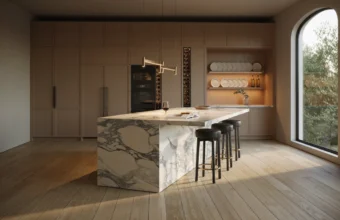 Modern luxury kitchen with marble waterfall island, taupe cabinets, arched window, and black stools