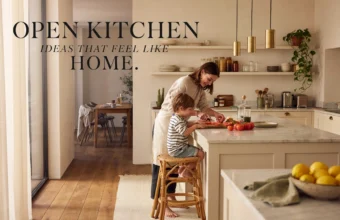 Modern open kitchen with a marble island where a mother and child prepare food together in a warm, bright open-concept home.